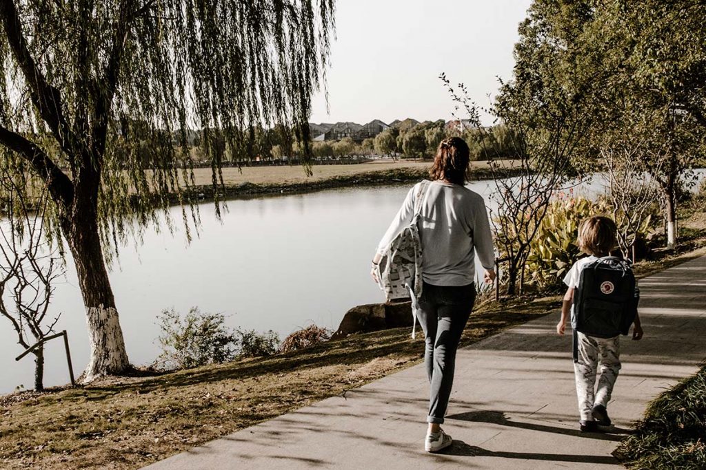 mom & son walking by lake